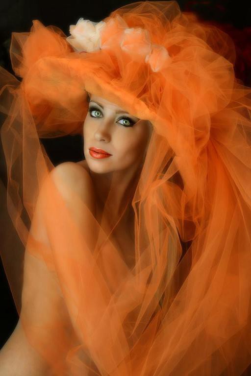 "Orange hat", splendid monochrome portrait ... Orange color, a beautiful face... It won gold medal in USA and in Macau and many honorable mentions ... typical Fairy Tales Beauty.