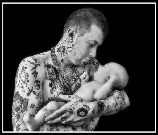 "Tattoo". Multi-awarded image that takes a sweet pause for a moment of tenderness between a modern father, full of tattoos, and a newborn son.
